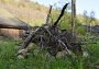 Reptile castle made of different sized round stones and branches. 